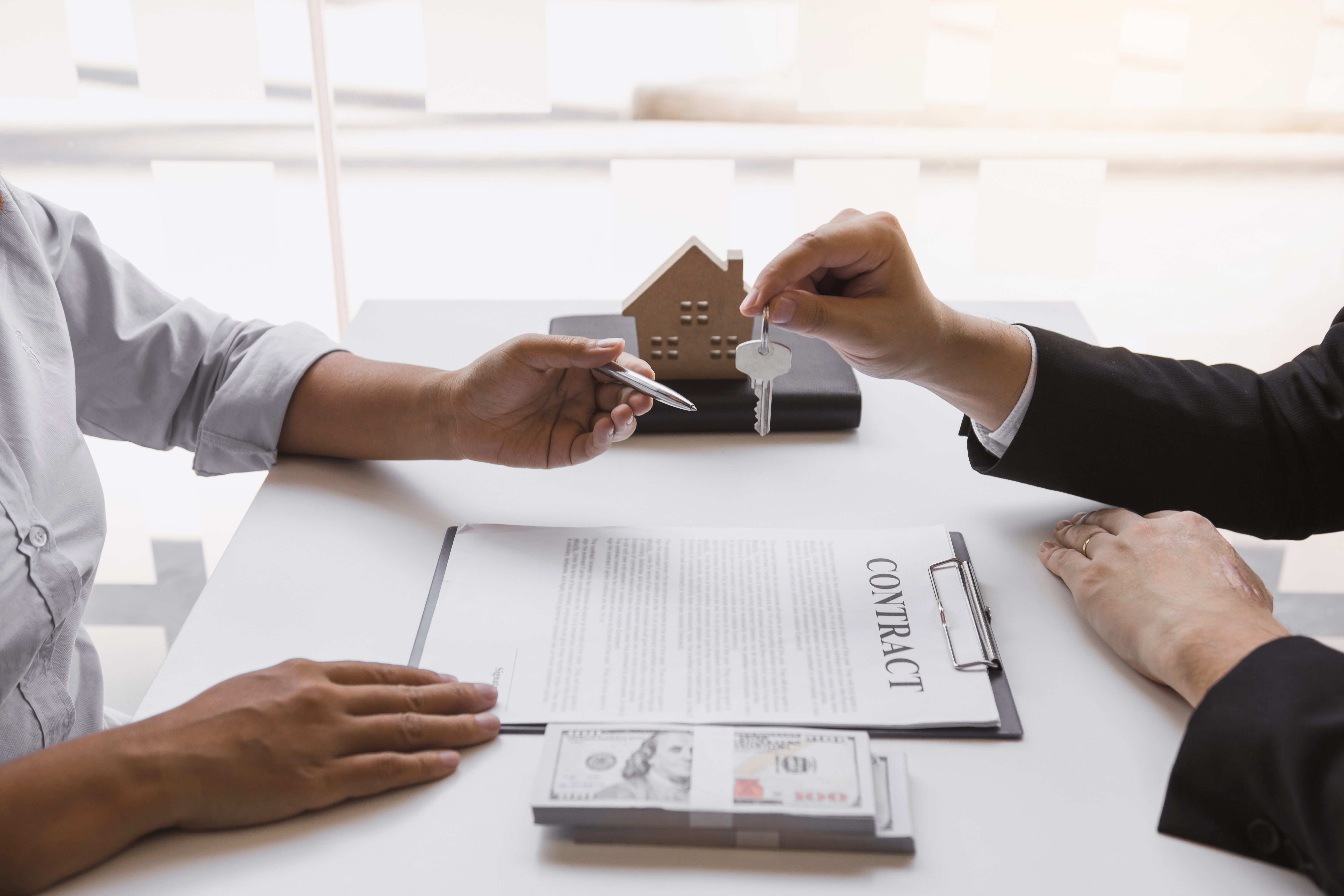 Insurance brokers are pointing to insurance contract signing and are explaining to customers at the office.